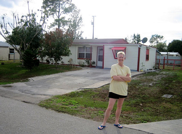 Judi Bordeaux in front of one of her childhood homes 45 years later, Lehigh Acres, FL, Feb. 2010