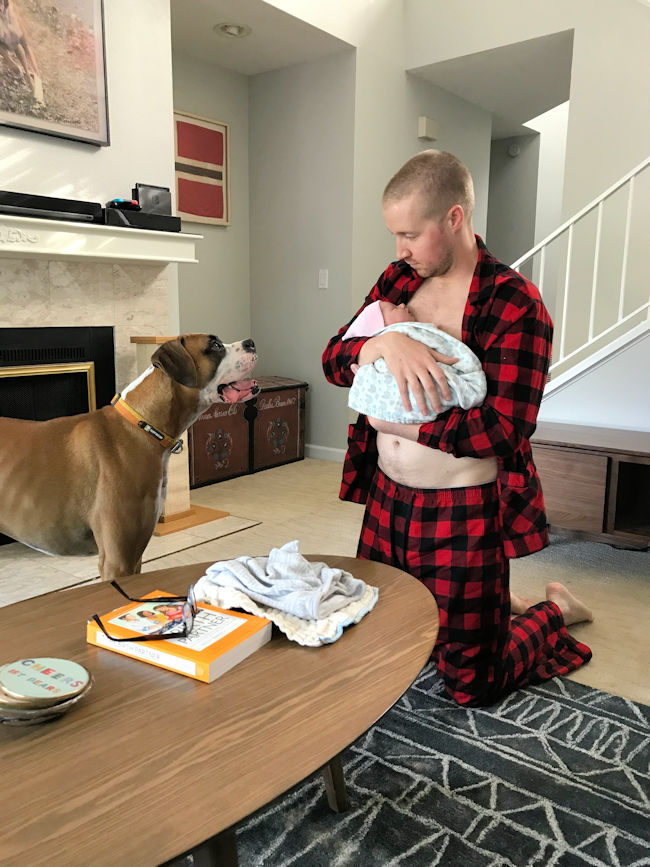 Pet dog and father Evan holding baby Marit