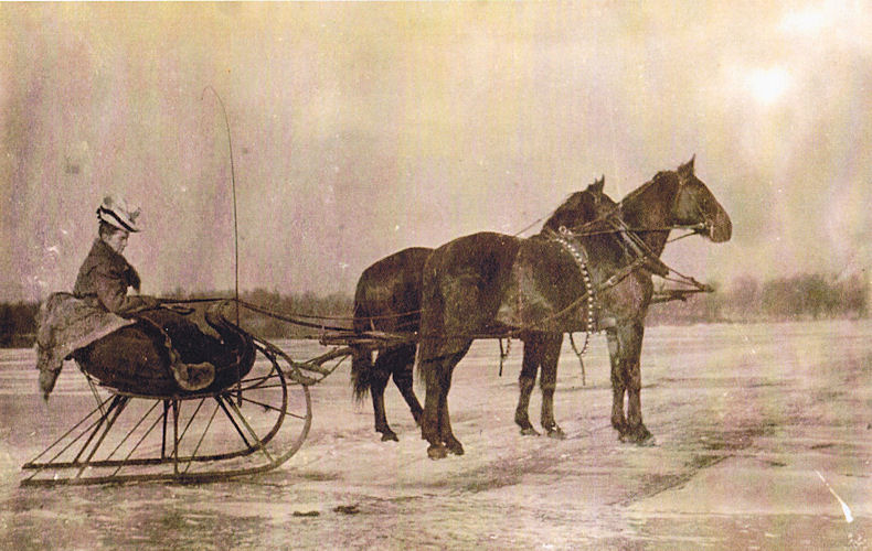 Jennie Jorgenson Qvale in horse-drawn sleigh on ice