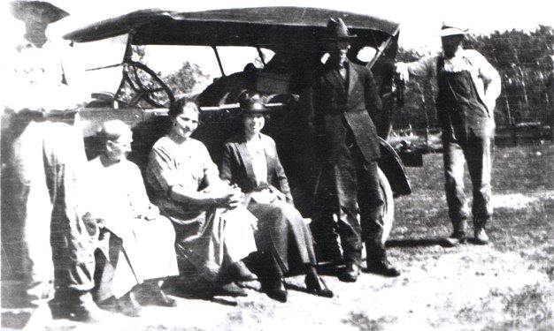 Kampa family around their car.