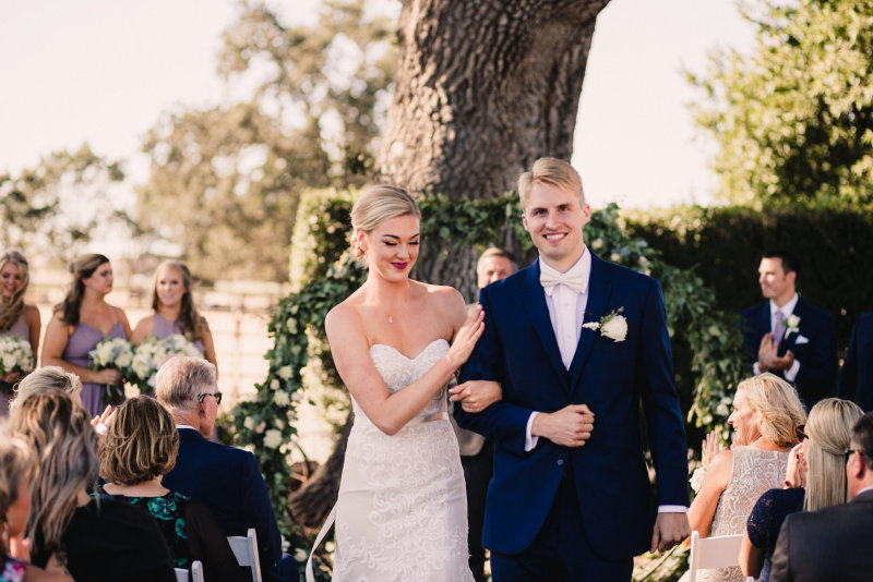Katie and Griffin walking down the aisle after the ceremony
