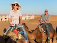 Jane and Mark Stimmler aboard camels in the Sahara Desert, Morocco, April 2014