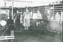 Parts department of the Stimler Ford garage with head mechanic Rube Stimler, owner Tony Stimler and daughter and bookkeeper Florence Stimler, 1929.