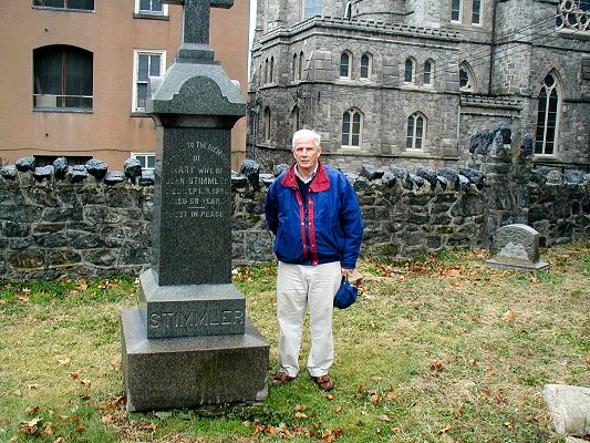 Gravestone of Johann Stimmler, Mary and Johann V. Stimmler with Paul T.J. Stimmler (Johann's great-grandson) standing nearby.