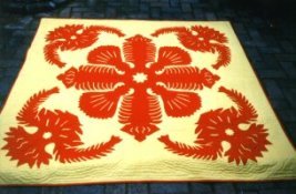 Dramatic traditional Hawaiian quilt with large floral motif.