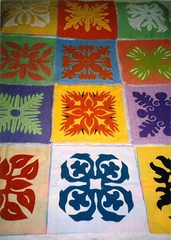 Hawaiian quilt with different blocks featuring variety of floral motifs.