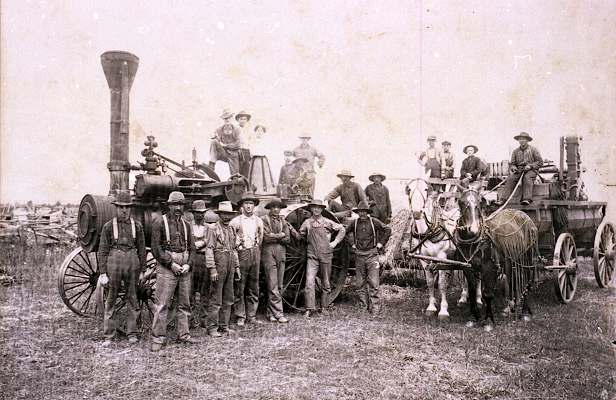 Paul Popilek's Thresher with two Dziuk Boys on the Tractor.