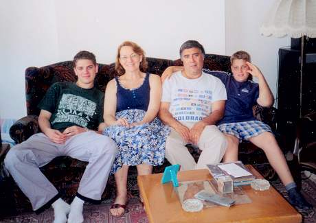 Reha Jr., Carol, Reha and Tracy Butros in the living room of their home in Mersin, Turkey, May 2001.