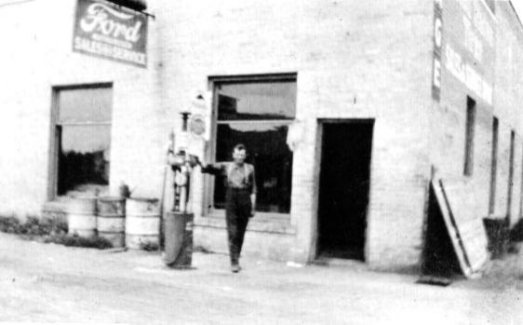 Tony Stimler Beside an Early Gas Pump, 1911.